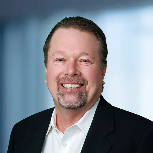 A photo of attorney, Eric Stubenvoll, against a softly blurred office background.