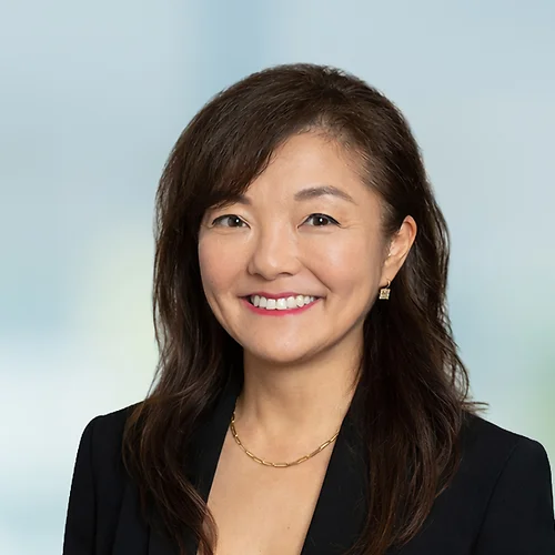 A photo of attorney Soojin Kang against a softly blurred office background