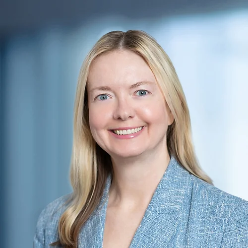 A photo of attorney, Katherine Den Bleyker, against a softly blurred office background