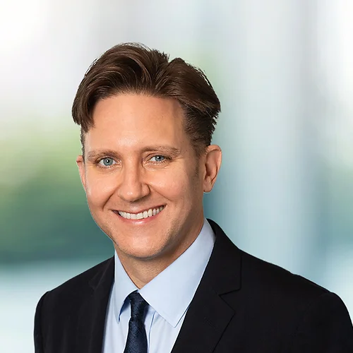 A photo of attorney John Haubrich against a softly blurred office background