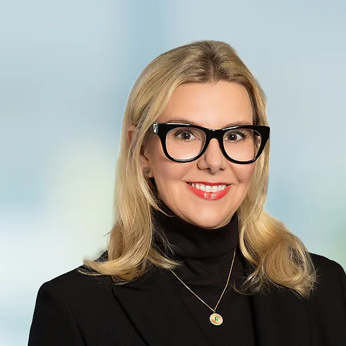 A photo of attorney Meghan McCord against a softly blurred office background